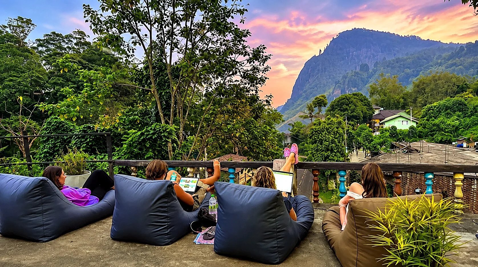 Guests watching the sunset from the terrace
at Rock View Hostel Ella, with Ella Rock
in the background